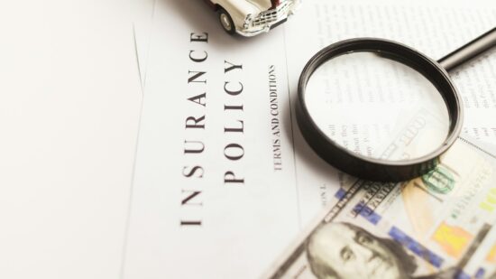 Certificate of motor insurance and policy with car and dollar bills.