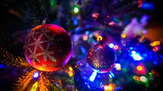 Ornaments and Christmas lights hanging on a tree